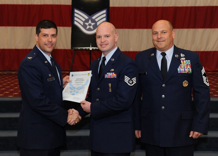Staff Sgt. Jeffrey Atha II, 2nd Aircraft Maintenance Squadron, receives a certificate of promotion from Col. Andrew Gebara, 2nd Bomb Wing commander, and Chief Master Sgt. Stephen Lebrun, 2nd Operations Group, during the February Wing Promotion Ceremony on Barksdale Air Force Base, La., Feb. 28, 2014. (U.S. Air Force photo/Senior Airman Joseph A. Pagán Jr.)