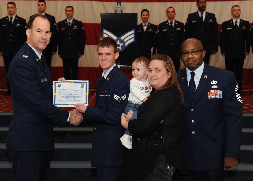 Senior Airman Matthew Smith, 608th Air and Space Operations Center, receives a certificate of promotion from Col. Russell Mathers, 8th Air Force vice commander, and Chief Master Sgt. Jeffrey Smith, 608th Air Operations Center, during the February Wing Promotion Ceremony on Barksdale Air Force Base, La., Feb. 28, 2014. (U.S. Air Force photo/Senior Airman Joseph A. Pagán Jr.)