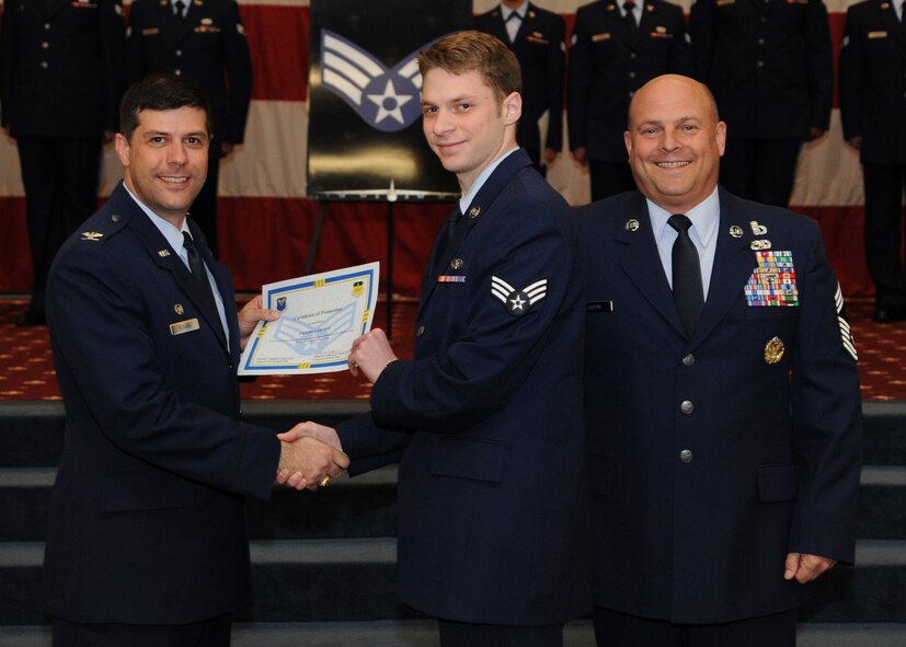 Senior Airman Anders Aarness, 26th Operational Weather Squadron, receives a certificate of promotion from Col. Andrew Gebara, 2nd Bomb Wing commander, and Chief Master Sgt. Stephen Lebrun, 2nd Operations Group, during the February Wing Promotion Ceremony on Barksdale Air Force Base, La., Feb. 28, 2014. (U.S. Air Force photo/Senior Airman Joseph A. Pagán Jr.)