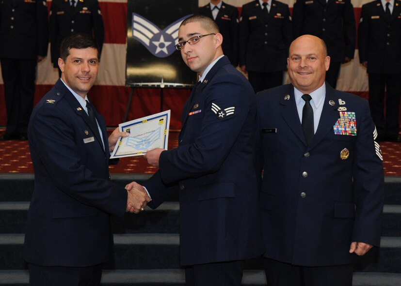 Senior Airman Joseph Stevens, 2nd Maintenance Squadron, receives a certificate of promotion from Col. Andrew Gebara, 2nd Bomb Wing commander, and Chief Master Sgt. Stephen Lebrun, 2nd Operations Group, during the February Wing Promotion Ceremony on Barksdale Air Force Base, La., Feb. 28, 2014. (U.S. Air Force photo/Senior Airman Joseph A. Pagán Jr.)