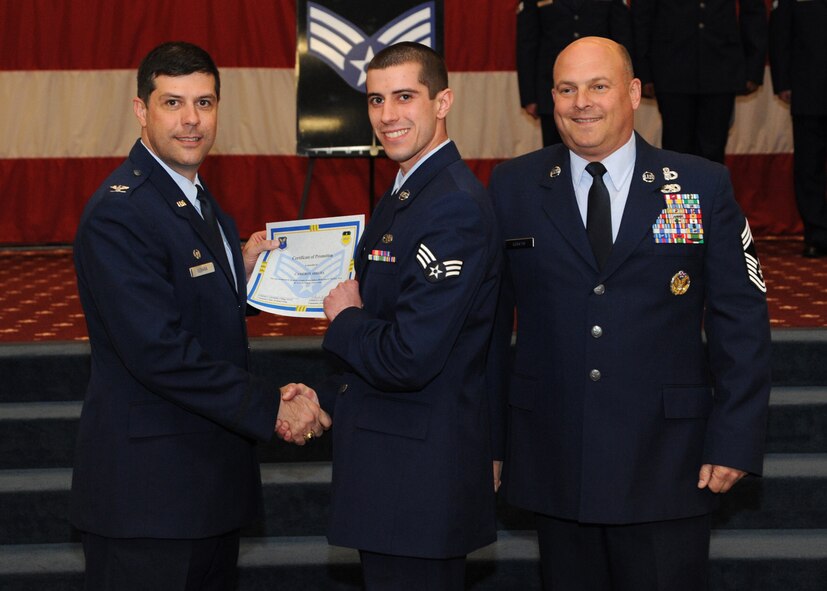 Senior Airman Cameron Arruda, 2nd Maintenance Squadron, receives a certificate of promotion from Col. Andrew Gebara, 2nd Bomb Wing commander, and Chief Master Sgt. Stephen Lebrun, 2nd Operations Group, during the February Wing Promotion Ceremony on Barksdale Air Force Base, La., Feb. 28, 2014. (U.S. Air Force photo/Senior Airman Joseph A. Pagán Jr.)