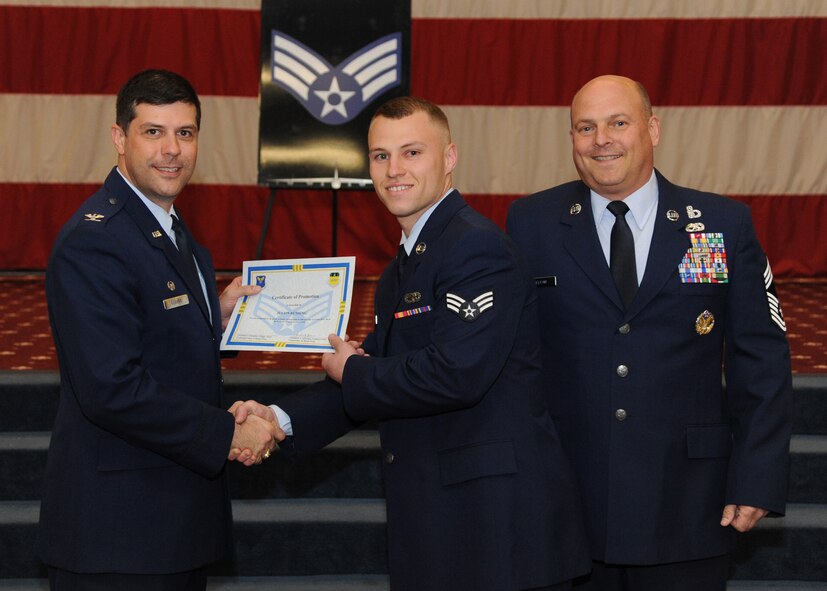 Senior Airman Justin Rushings, 2nd Logistics Readiness Squadron, receives a certificate of promotion from Col. Andrew Gebara, 2nd Bomb Wing commander, and Chief Master Sgt. Stephen Lebrun, 2nd Operations Group, during the February Wing Promotion Ceremony on Barksdale Air Force Base, La., Feb. 28, 2014. (U.S. Air Force photo/Senior Airman Joseph A. Pagán Jr.)