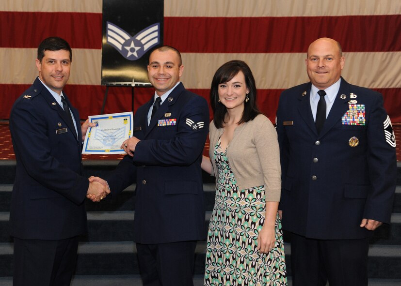 Senior Airman Donny Caffey Jr., 2nd Logistics Readiness Squadron, receives a certificate of promotion from Col. Andrew Gebara, 2nd Bomb Wing commander, and Chief Master Sgt. Stephen Lebrun, 2nd Operations Group, during the February Wing Promotion Ceremony on Barksdale Air Force Base, La., Feb. 28, 2014. (U.S. Air Force photo/Senior Airman Joseph A. Pagán Jr.)