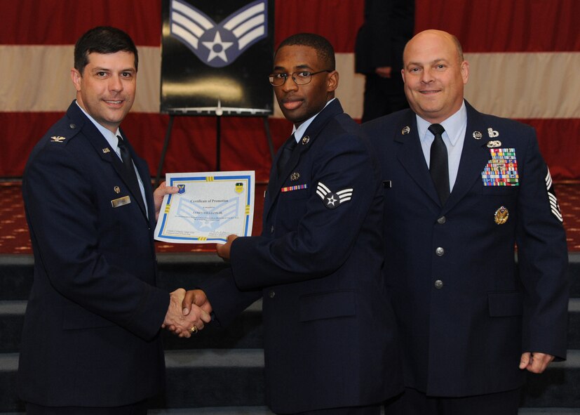 Senior Airman James Williams Jr., 2nd Civil Engineer Squadron, receives a certificate of promotion from Col. Andrew Gebara, 2nd Bomb Wing commander, and Chief Master Sgt. Stephen Lebrun, 2nd Operations Group, during the February Wing Promotion Ceremony on Barksdale Air Force Base, La., Feb. 28, 2014. (U.S. Air Force photo/Senior Airman Joseph A. Pagán Jr.)