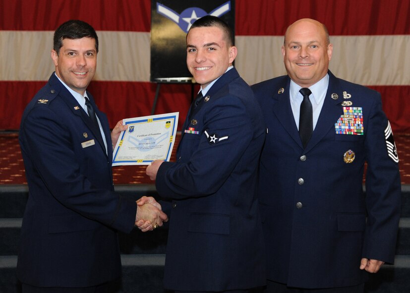 Airman 1st Class Quinton Lawson, 2nd? Aircraft Maintenance Squadron, receives a certificate of promotion from Col. Andrew Gebara, 2nd Bomb Wing commander, and Chief Master Sgt. Stephen Lebrun, 2nd Operations Group, during the February Wing Promotion Ceremony on Barksdale Air Force Base, La., Feb. 28, 2014. (U.S. Air Force photo/Senior Airman Joseph A. Pagán Jr.)