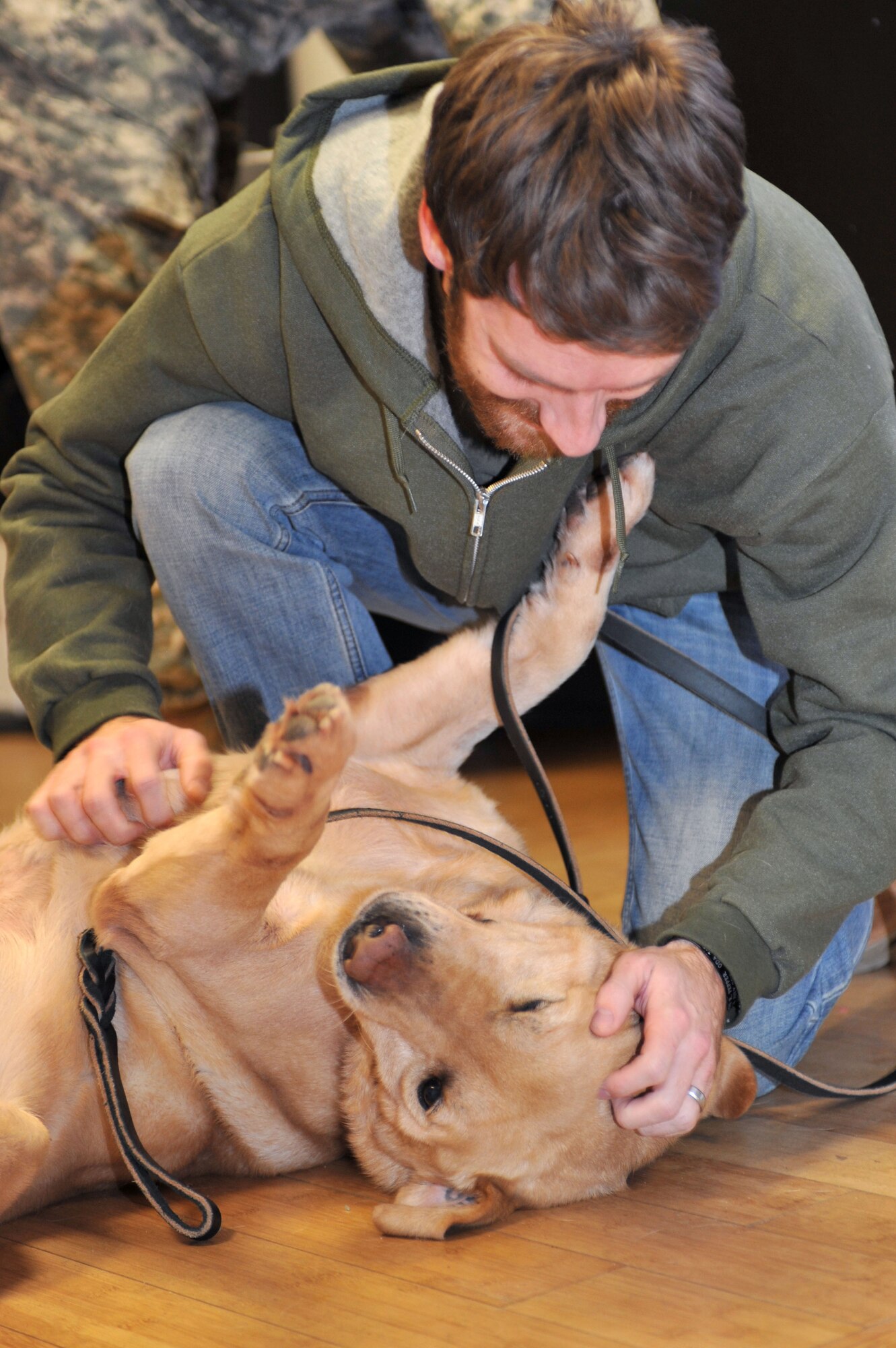 U.S. Army Sgt. John Nolan, former senior specialized-search dog handler previously assigned to the 3rd Military Police Detachment, greets his partner Honza, a 7-year-old SSD, after a two-month separation, at Fort Eustis, Va., Feb. 28, 2014.  The two were deployed to Afghanistan for a year, where Nolan said they grew a strong bond. Nolan is a native of Wilkes-Barre, Pa. (U.S. Air Force photo by Staff Sgt. Katie Gar Ward/Released)