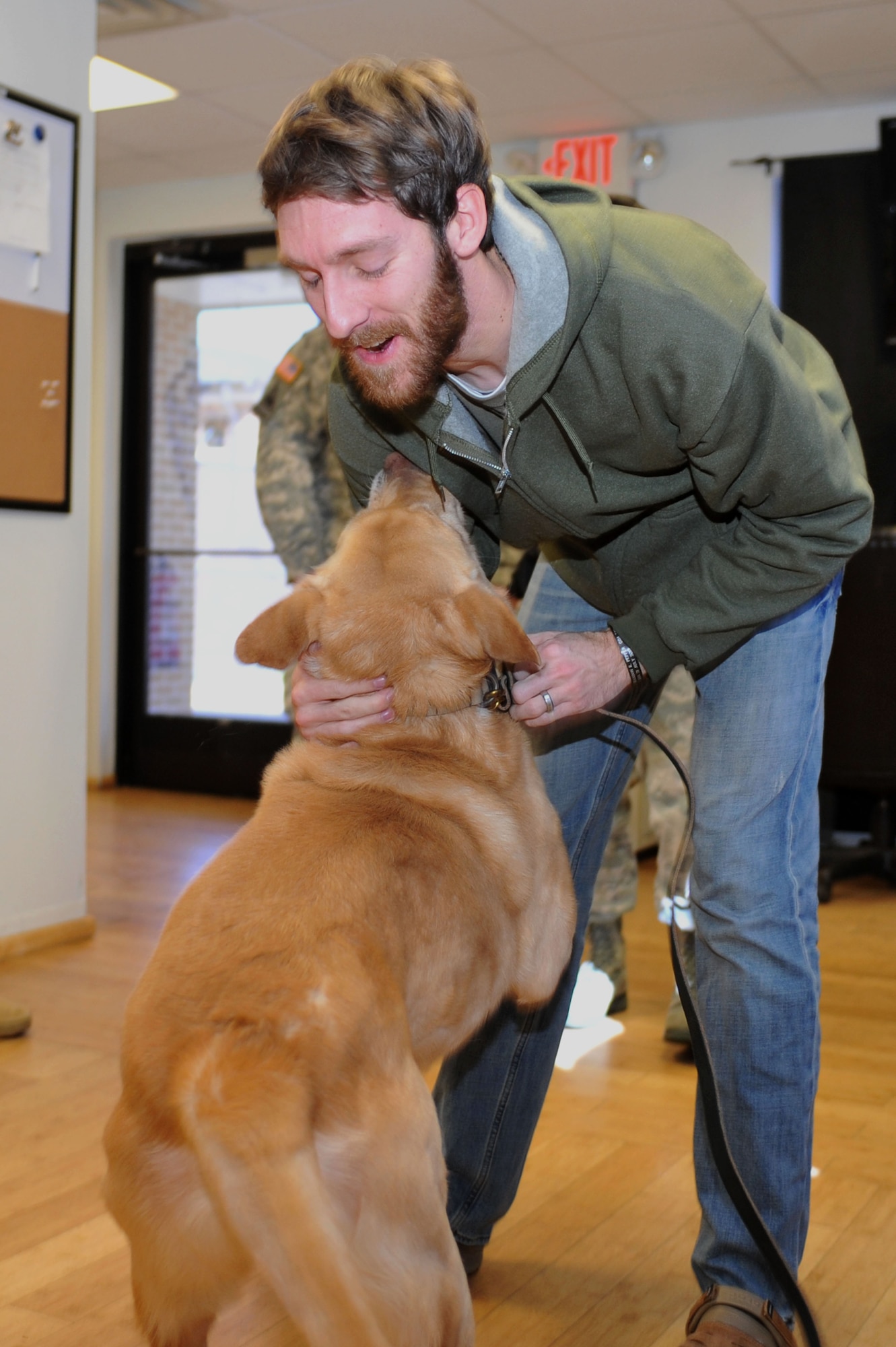 U.S. Army Sgt. John Nolan, former senior specialized-search dog handler previously assigned to the 3rd Military Police Detachment, greets his partner Honza, a 7-year-old SSD, after a two-month separation, at Fort Eustis, Va., Feb. 28, 2014.  Nolan and Honza have been partners since January 2011, and are now able to maintain that bond through adoption, as both separate from military service. Nolan is a native of Wilkes-Barre, Pa.  (U.S. Air Force photo by Staff Sgt. Katie Gar Ward/Released)