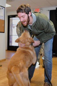 U.S. Army Sgt. John Nolan, former senior specialized-search dog handler previously assigned to the 3rd Military Police Detachment, greets his partner Honza, a 7-year-old SSD, after a two-month separation, at Fort Eustis, Va., Feb. 28, 2014.  Nolan and Honza have been partners since January 2011, and are now able to maintain that bond through adoption, as both separate from military service. Nolan is a native of Wilkes-Barre, Pa.  (U.S. Air Force photo by Staff Sgt. Katie Gar Ward/Released)