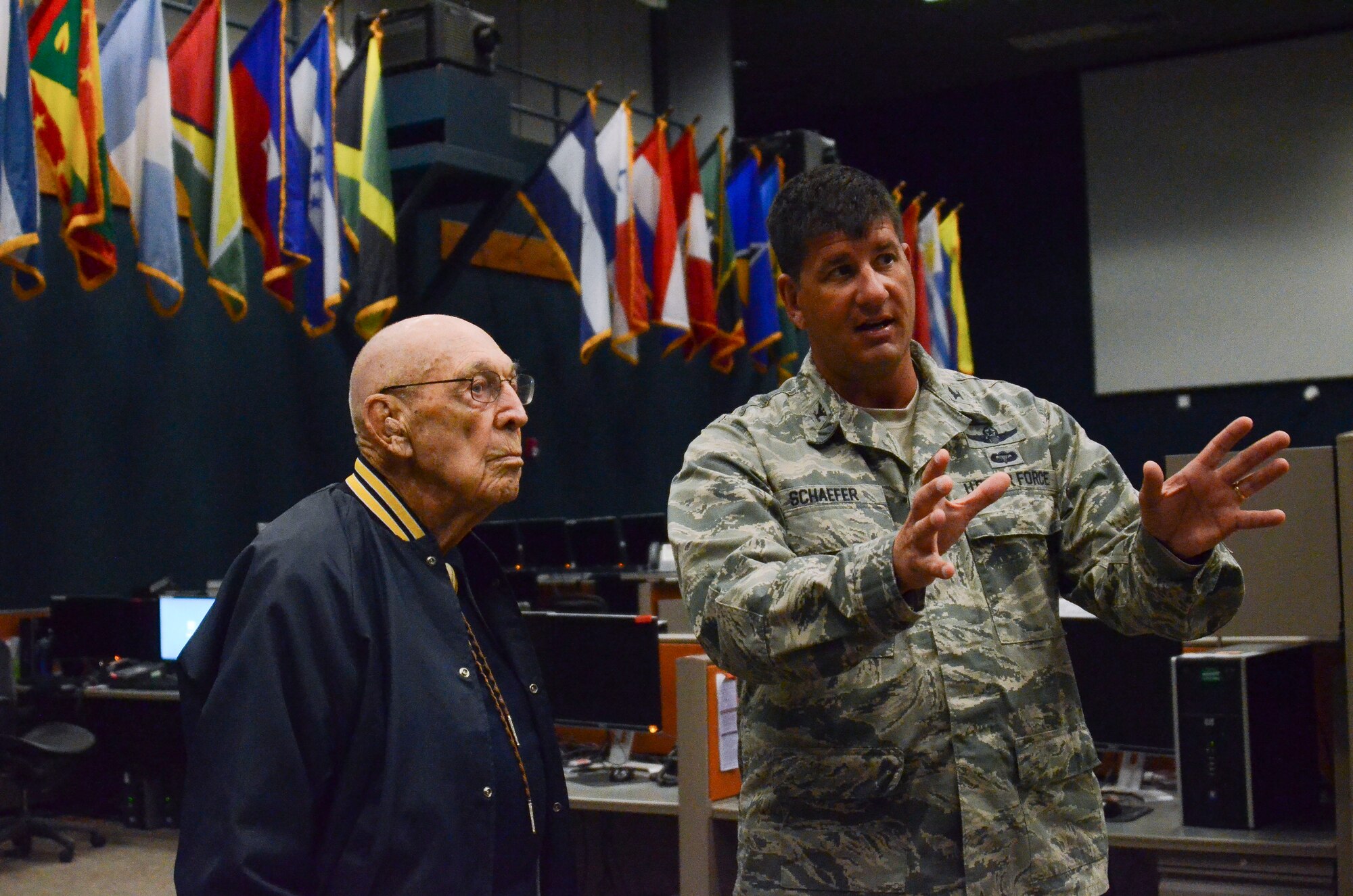 Col. John Schaefer, command of the 612th Air and Space Operations Center, gives a tour to Lt. Col. Richard Cole, a retired Doolittle Raider, on Davis-Monthan AFB, Ariz., Feb. 25, 2014.  The 612th AOC provides command and control of air and space power in United States Southern Command's area of responsibility that include 31 countries. The building was named the James H. Doolittle Center in honor of the Doolittle Tokyo Raiders.