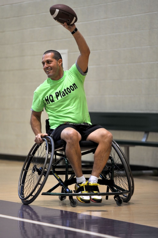 U.S. Army Capt. Travis Robinette, former Alpha Company, Fort Eustis Warrior Transition Unit company commander, celebrates a touchdown during a WTU’s Sports Week adaptive football game at Fort Eustis, Va., Feb. 27, 2014. The WTU’s mission is to help wounded, ill or injured Soldiers seamlessly reintegrate back into Army units or transition to civilian life.
 (U.S. Air Force photo by Staff Sgt. Katie Gar Ward/Released)