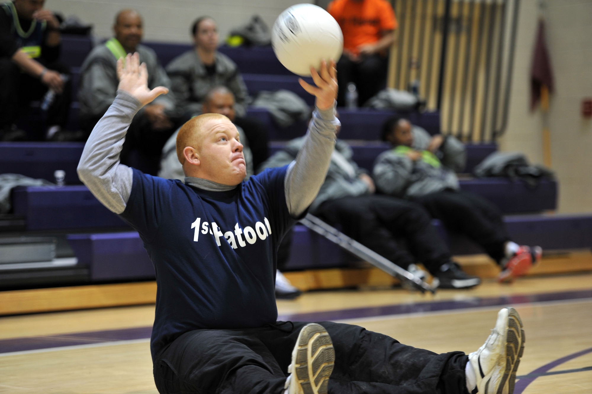 U.S. Army Spc. Brandon Goodrich,  a transitioning Soldier assigned to 1st Platoon, Alpha Company, Fort Eustis Warrior Transition Unit, serves during adaptive volleyball at the WTU’s Sports Week at Fort Eustis, Va., Feb. 27, 2014. The WTU hosts quarterly adaptive-sports events to help facilitate recovery and foster esprit de corps. (U.S. Air Force photo by Staff Sgt. Katie Gar Ward/Released)

