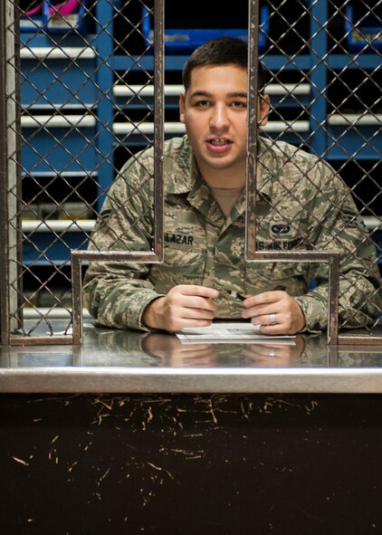 Senior Airman David Salazar, 5th Security Forces Squadron staff armor calls for the next Airman in line during weapons issue at Minot Air Force Base, N.D. Jan. 30. After a weapon is issued it is taken to the clearing barrels for check before being loaded. (U.S. Air Force photo/Senior Airman Stephanie Sauberan)