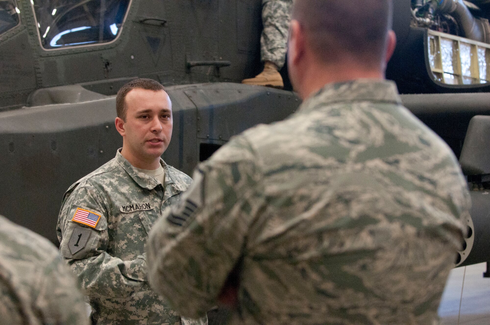 Sgt. Zachory McMahon explains how to use a Unit Maintenance Aerial Recovery Kit to Airmen at Simmons Army Airfield, Feb. 24. 82nd Combat Aviation Brigade troops hosted joint Downed Aircraft Recovery Team and Crash Damaged Disabled Aircraft Recovery training with Airmen from Pope Army Airfield at Simmons Army Airfield. Soldiers from 122nd Aviation Support Battalion and 1-82 Attack Reconnaissance Battalion, and Airmen from 440th Maintenance Group and 2nd Airlift Squadron, 43rd Airlift Group, practiced using the Unit Maintenance Aerial Recovery Kit on an AH-64 Apache helicopter. DART and CDDAR teams are responsible for recovering aircraft after they crash or become disabled and can no longer fly. (Photo by U.S. Army Staff Sgt. April Campbell, 82nd Combat Aviation Brigade Public Affairs)
