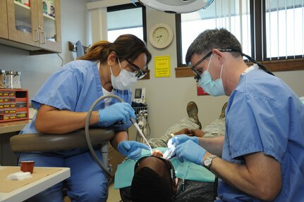 Lorna Firehammer (left), 359th Aerospace-Medicine Squadron Dental Flight dental assistant, helps Lt. Col. James Kutner, 359th AMDS Dental Flight commander, during a procedure Jan. 22 at the Joint Base San Antonio- Randolph Dental Clinic. (U.S. Air Force photo by Rich McFadden)