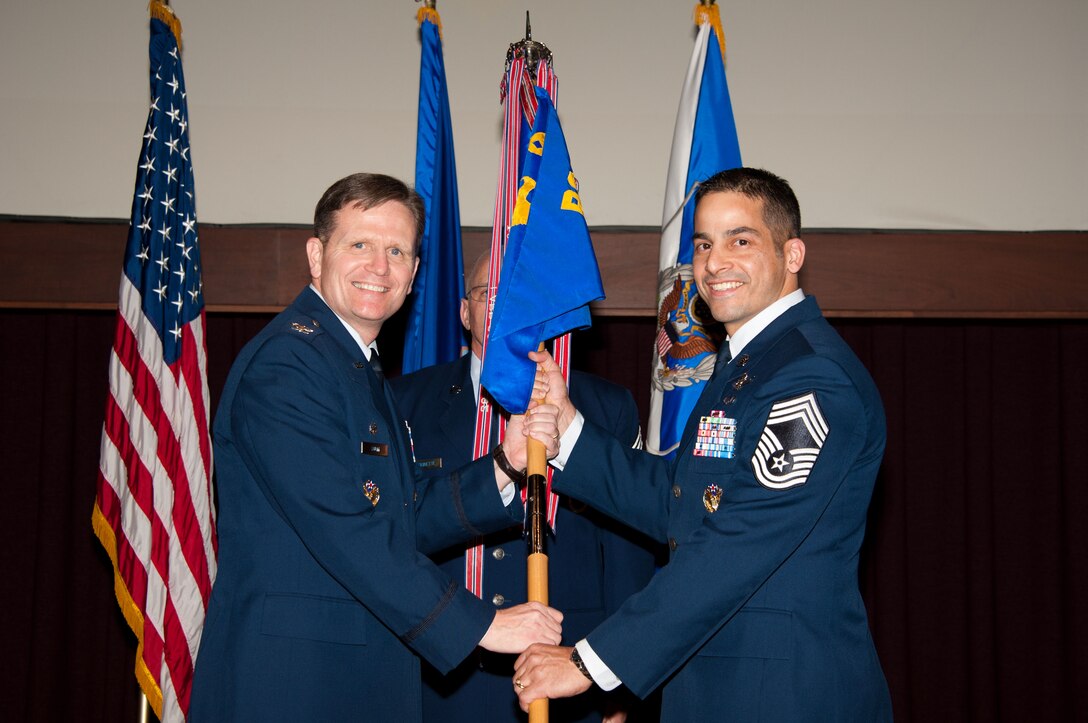 Col. Jeff Dunn, commander of the Thomas N. Barnes Center for Enlisted
Education, hands the unit flag to Chief Master Sgt. Benjamin Caro Jr., new
commandant for the Air Force Senior NCO Academy, during the change of
responsibility ceremony at the academy Feb. 28. Caro's previous duty
assignment was as chief, enlisted force development, Headquarters U.S. Air
Force, the Pentagon, Washington, D.C. The former commandant, Chief Master
Sgt. Kevin Candler, retired from the Air Force following 29 years of
service. (Air Force photo by Bud Hancock)
