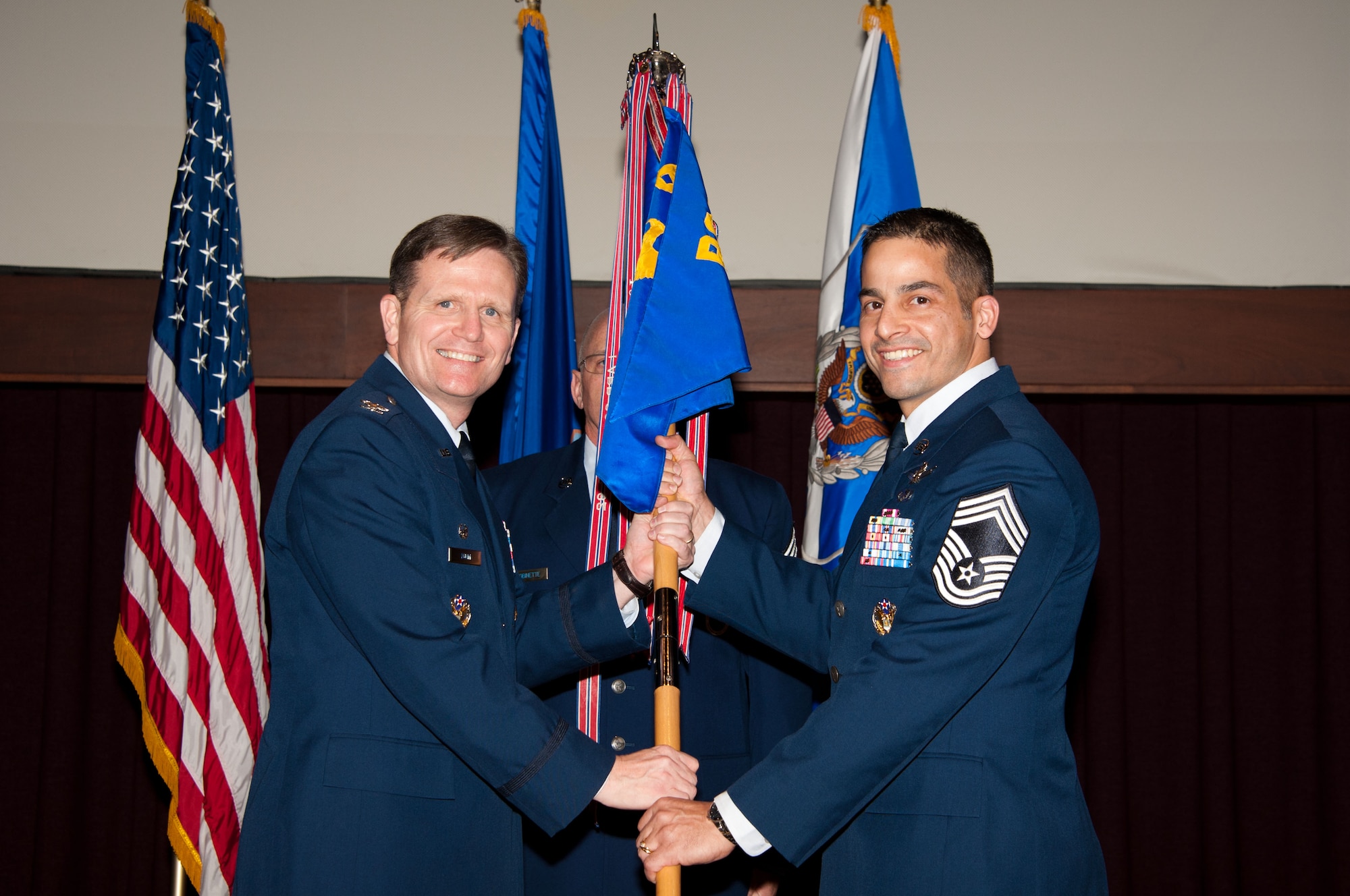 Col. Jeff Dunn, commander of the Thomas N. Barnes Center for Enlisted
Education, hands the unit flag to Chief Master Sgt. Benjamin Caro Jr., new
commandant for the Air Force Senior NCO Academy, during the change of
responsibility ceremony at the academy Feb. 28. Caro's previous duty
assignment was as chief, enlisted force development, Headquarters U.S. Air
Force, the Pentagon, Washington, D.C. The former commandant, Chief Master
Sgt. Kevin Candler, retired from the Air Force following 29 years of
service. (Air Force photo by Bud Hancock)
