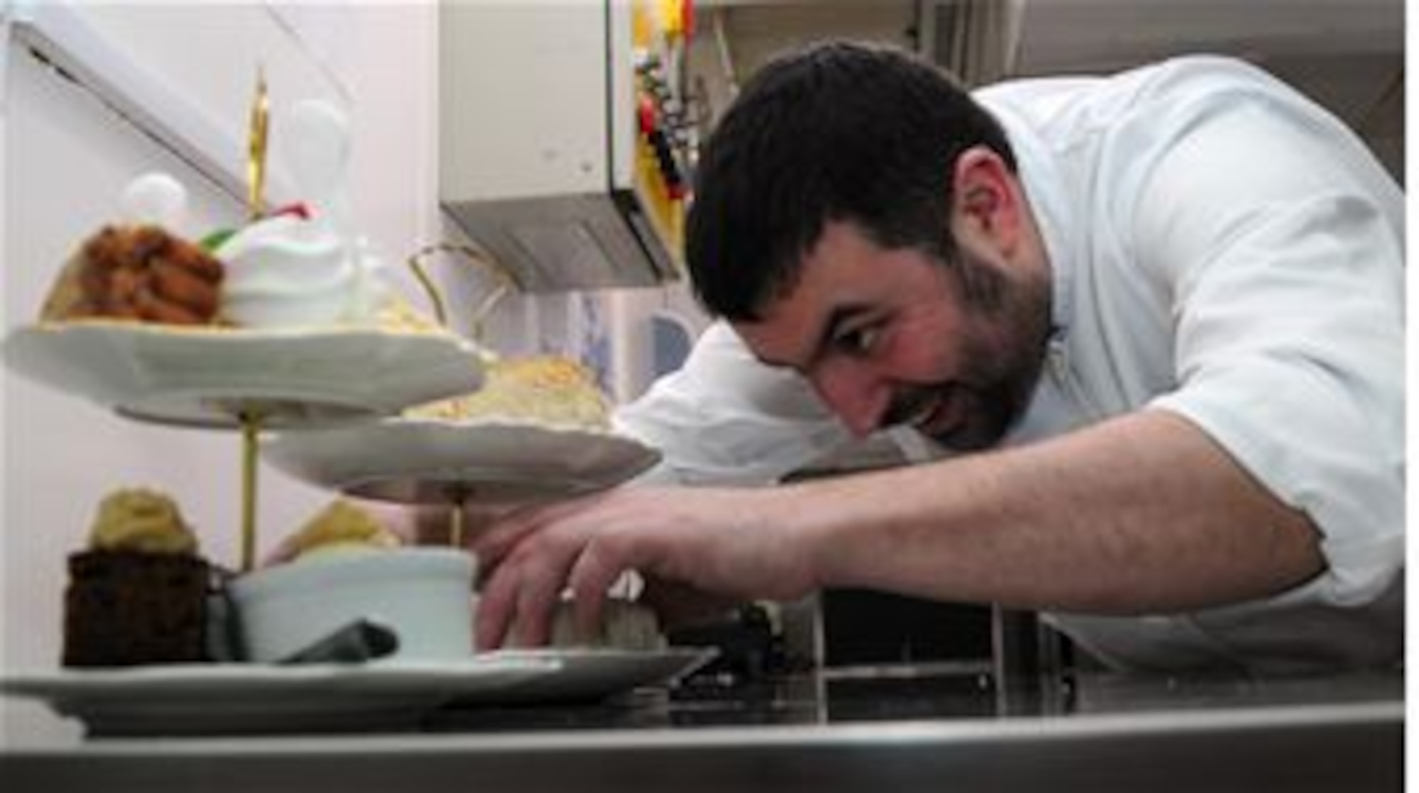 Justin Kett, The Swan hotel head chef from Wenhastone, Suffolk, puts the finishing touches to a traditional English Afternoon Tea for Two Feb. 21, 2014, in Lavenham, Suffolk. English cream teas are just one of the delightful traditionally English features of the town. Lavenham dates back to medieval times and made its fortunes as a wool town. The crooked, half-timbered houses make it a big tourist attraction in East Anglia. (U.S. Air Force photo by Karen Abeyasekere/Released)