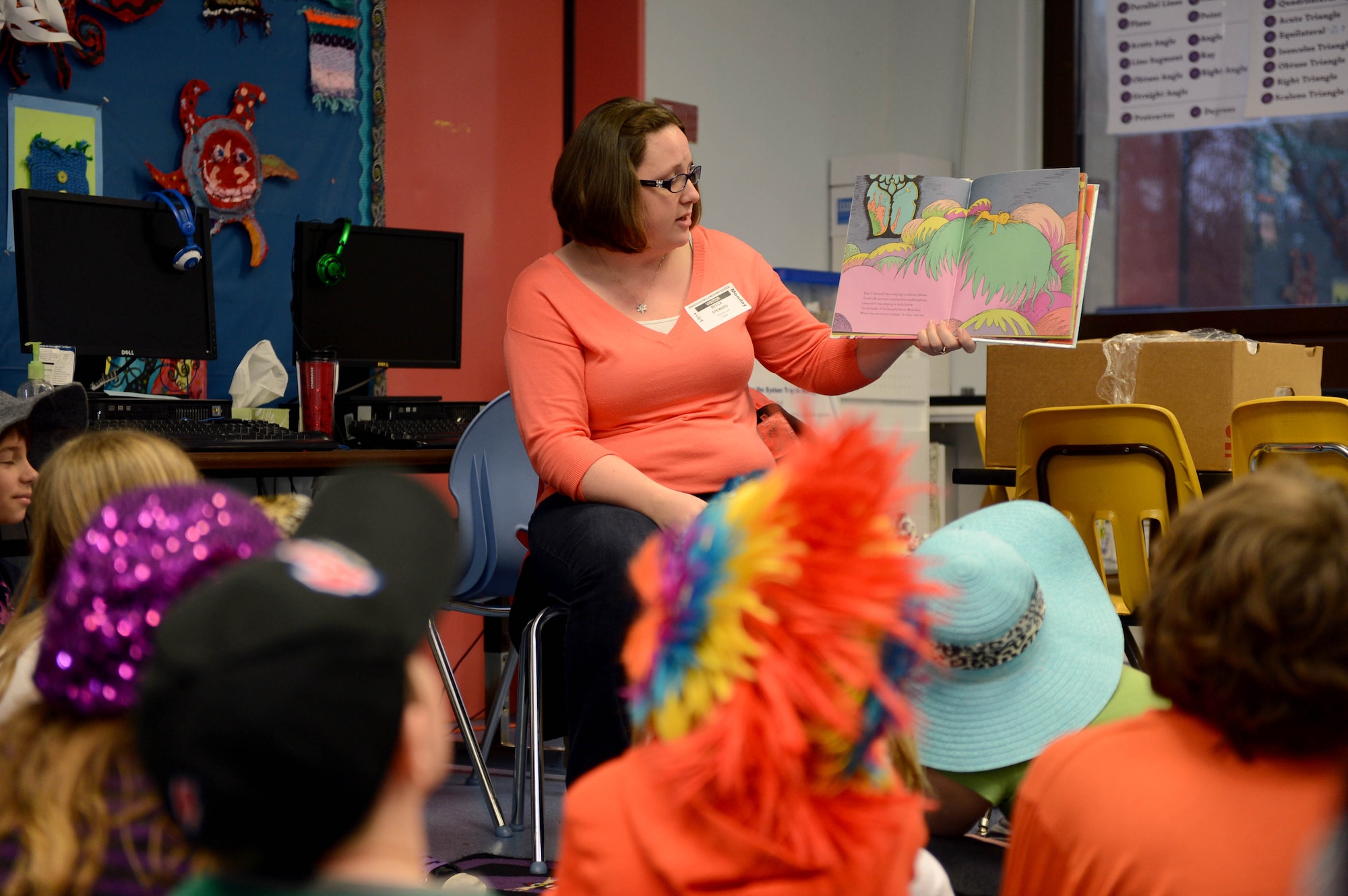 Becca Stewart, wife of 1st Lt. Jason Stewart, 606th Air Control Squadron, reads to elementary school children during a Read Across America event at Spangdahlem Air Base, Germany, March 3, 2014. Students across America celebrate the birth of Dr. Seuss by reading books March 2. (U.S. Air Force photo by Airman 1st Class Kyle Gese/Released)