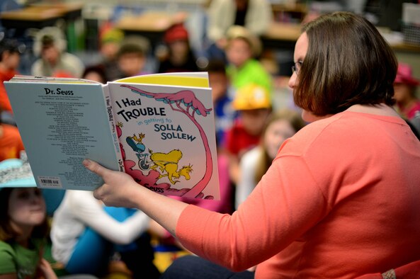 Becca Stewart, wife of 1st Lt. Jason Stewart, 606th Air Control Squadron, reads to elementary school children during a Read Across America event at Spangdahlem Air Base, Germany, March 3, 2014. Read Across America was held in honor of Dr. Seuss’s birthday, March 2, 1904. (U.S. Air Force photo by Airman 1st Class Kyle Gese/Released)
