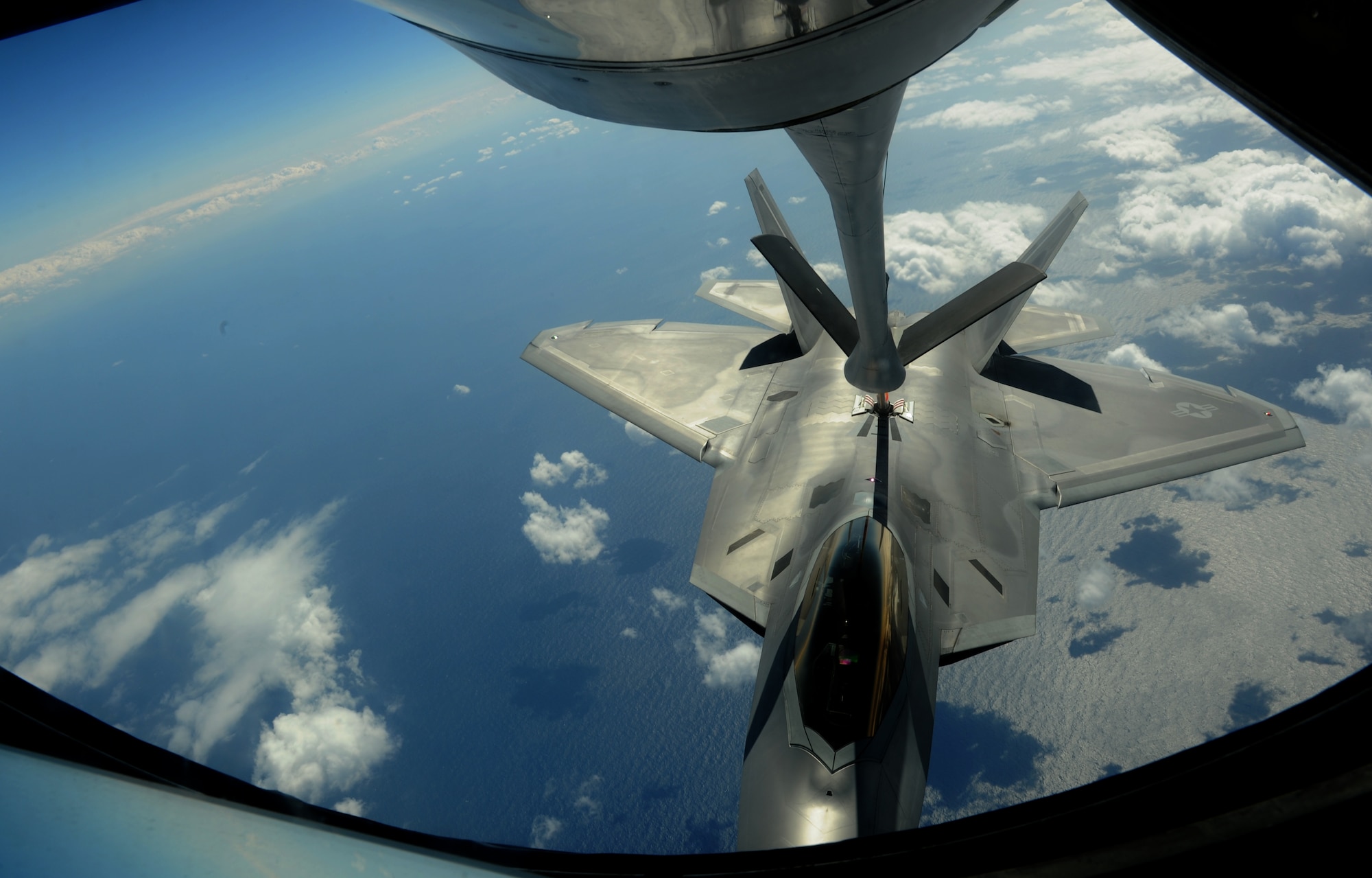 A U.S. Air Force KC-135 Stratotanker from the 909th Air Refueling Squadron Kadena Air Base, Japan, refuels an F-22 Raptor from Joint Base Langley-Eustis, Va., Feb. 21, 2014. The 909th ARS "Young Tigers" are a crucial part in the 18th Wing mission, providing air refueling support to multiple aircraft from Kadena and regional allies. (U.S. Air Force photo by Airman 1st Class Keith James)