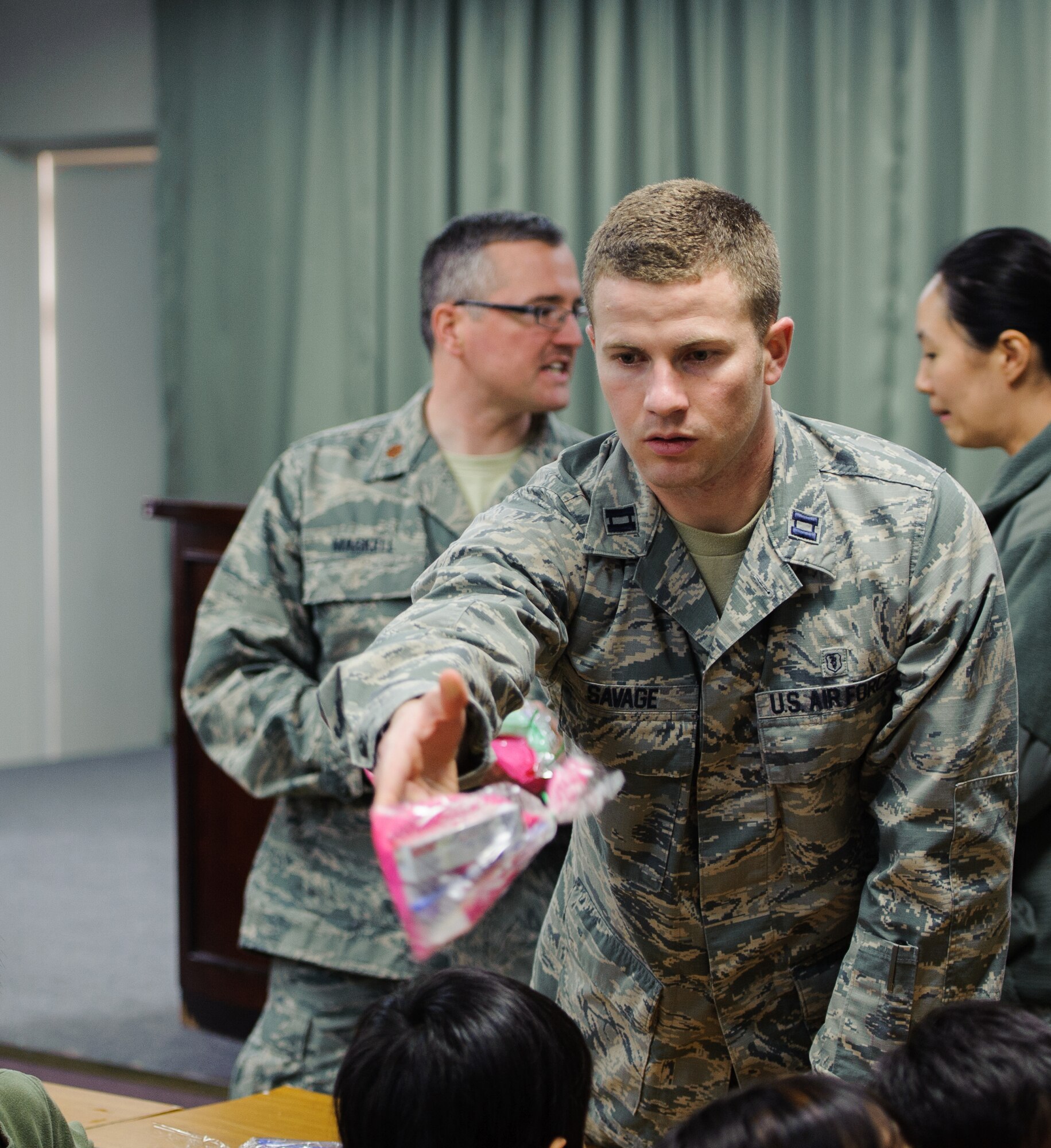 Capt. Steven Savage, 8th Medical Operations Squadron dentist, hands out a goody bag to children during a visit to the Ilmaekwon Orphanage in Gunsan, Republic of Korea, Feb. 27, 2014. The dental clinic visited the orphanage to teach kids proper oral hygiene knowledge and skills as part of the 2014 National Children’s Dental Health Month. (U.S. Air Force photo by Senior Airman Armando A. Schwier-Morales/Released)