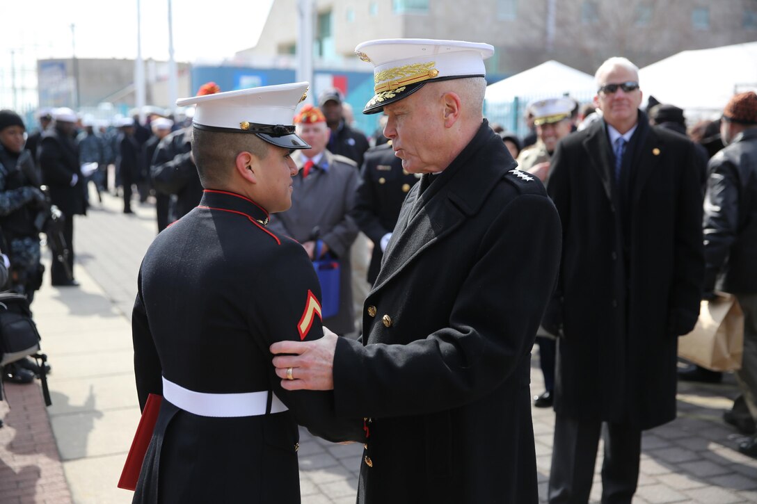 Gen. James F. Amos (right), the 35th Commandant of the Marine Corps, speaks with Lance Cpl. Uriel Reyes Jr. (left), a Santa Ana, Calif., native and school clerk for Headquarters and Support Company, 8th Engineer Support Battalion, 2nd Marine Logistics Group, after promoting him from private first class to lance corporal at Penn’s Landing, Philadelphia, March 1, 2014. The commandant promoted Reyes after the commissioning ceremony for the USS Somerset, named in honor of the passengers of United Airlines Flight 93, who fought terrorist attempts to hijack their plane on Sept. 11, 2001.
