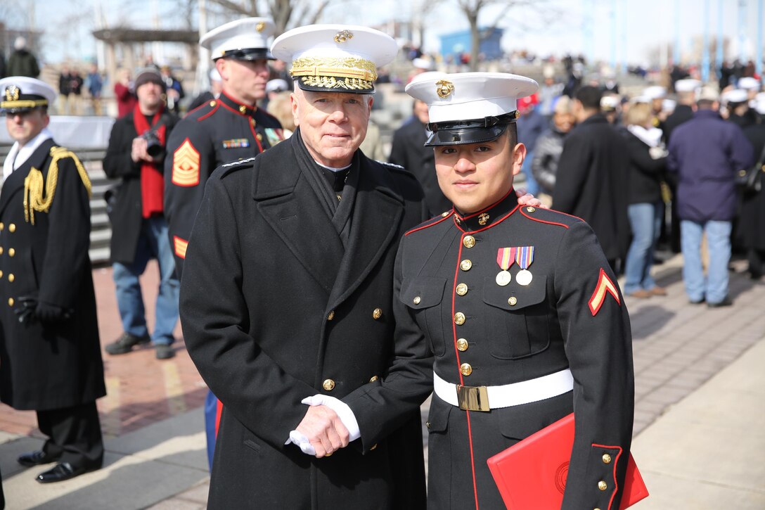 Gen. James F. Amos (left), the 35th Commandant of the Marine Corps, and Lance Cpl. Uriel Reyes Jr. (right), a Santa Ana, Calif., native and school clerk for Headquarters and Support Company, 8th Engineer Support Battalion, 2nd Marine Logistics Group, pose for a photo after Reyes’ promotion from private first class to lance corporal at Penn’s Landing, Philadelphia, March 1, 2014. The commandant had Reyes repeat the oath of enlistment during his promotion ceremony.
