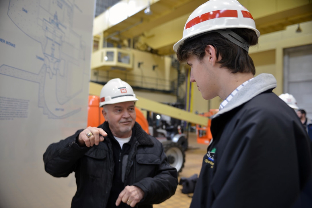 Hydropower Plant Project Manager Randy Crabtree at Old Hickory Dam explains how the dam  hydropower is operated and controlled to Montgomery Bell Academy student Donovan Sohr during a project tour Feb. 28, 2014. (USACE photo by Mark Rankin) 