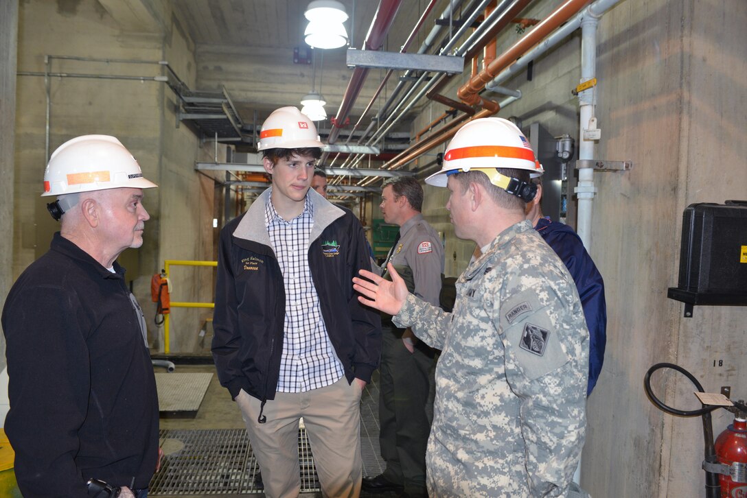 Hydropower Plant Project Manager Randy Crabtree from the Old Hickory Dam looks on (left) and Lt. Col. John L. Hudson, Nashville District commander (Right) talks with Donovan Sohr,(center) a sophomore student from Montgomery Bell Academy in Nashville, Tenn., during a tour at the Old Hickory dam in Hendersonville, Tenn., on Feb. 28, 2014.