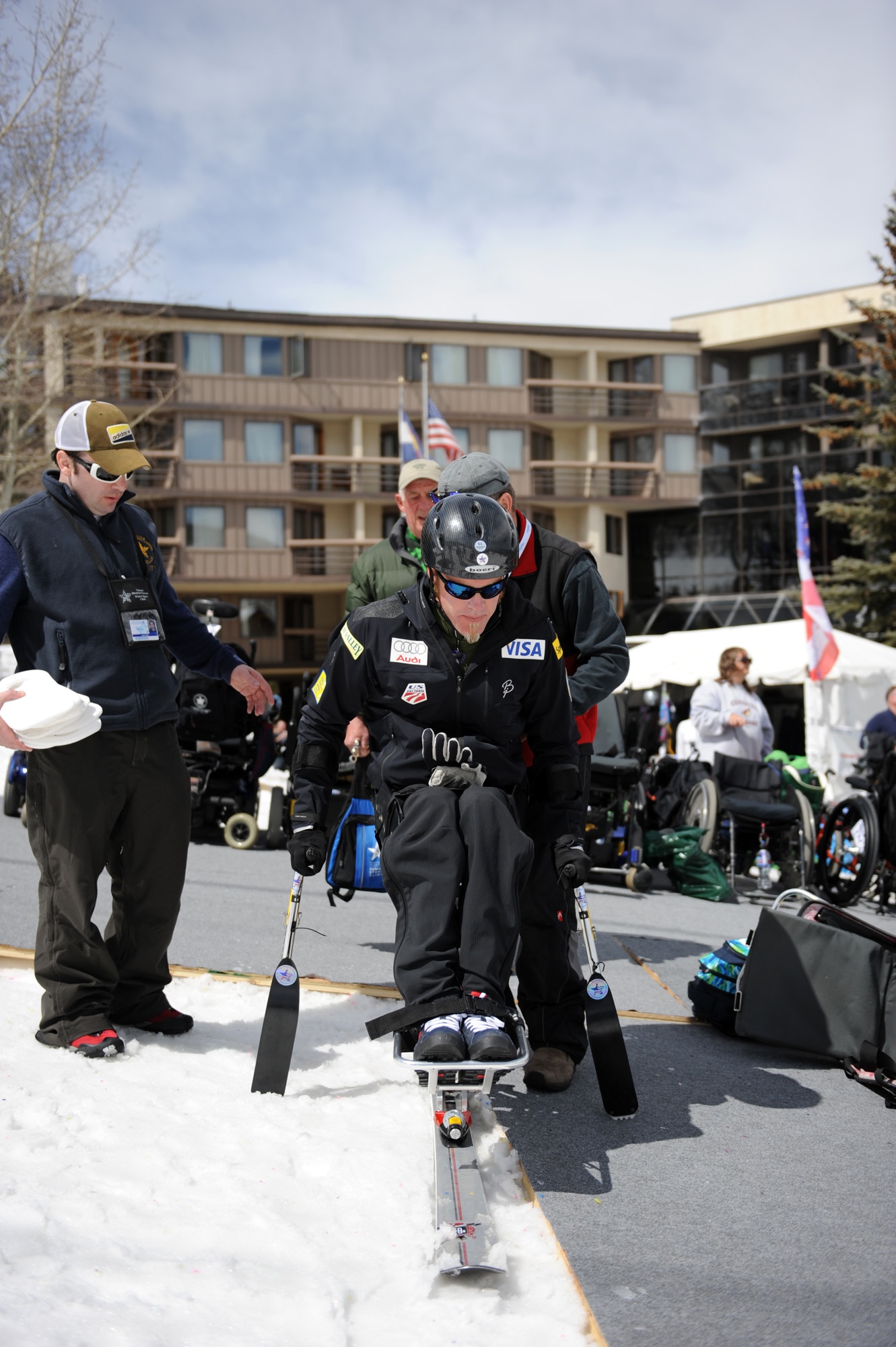 Sean Halsted gets strapped into a mono-ski outside The Silvertree Hotel March 30 for the 24th National Disabled American Veterans Winter Sports Clinic in Snowmass Village, Colo. Halsted is an Air Force veteran who will be competing in the 2014 Sochi Paralympic Winter Games. (U.S. Air Force photo/Desiree N. Palacios)
