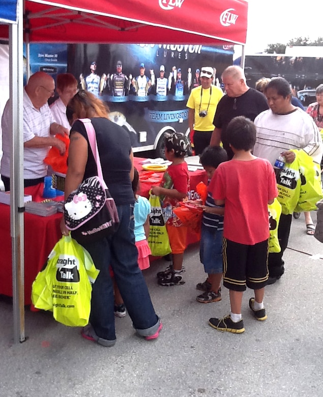 Corps volunteers Carol and Herb Sones provide water safety information to families in Clewiston during the FLW fishing tournament on Lake Okeechobee.