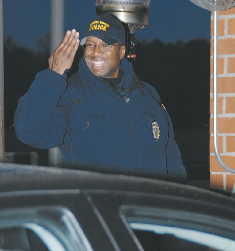 Zachary Robinson, police officer, Marine Corps Police Department, Public Safety Division, Marine Corps Logistics Base Albany, greets Tuesday morning traffic with a smile as personnel enter the Main Gate.