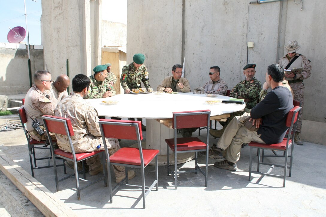 Brigadier Gen. Daniel D. Yoo, center-right, Regional Command (Southwest) commanding general, sits with 215th Corps Chief of Staff, Brig. Gen. Zamen Hassan, right of Brig. Gen. Yoo, Marine Expeditionary Brigade - Afghanistan staff, Marines with Security Force Assistance Advisor Team 4-215 and Afghan officials during a security shura aboard Forward Operating Base Delaram, Nimroz province, Afghanistan, March 4, 2014. During the shura, the Marines and Afghan officials discussed the upcoming presidential election and security measures being emplaced to ensure the safety of the local people.