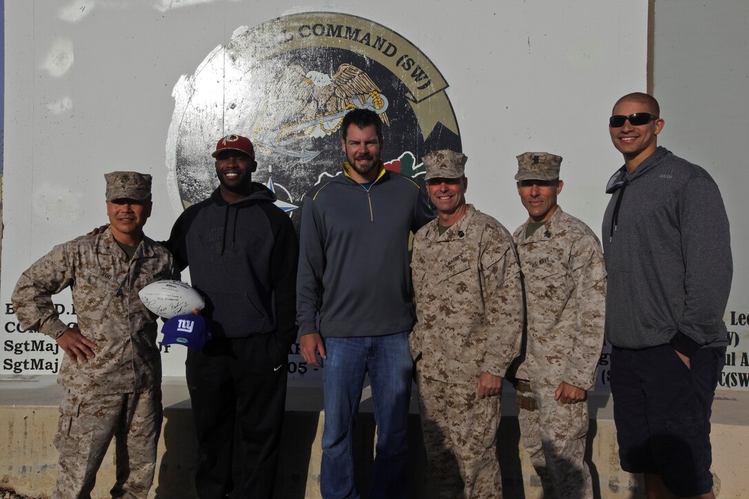 From left to right, Brig. Gen. Daniel D. Yoo, commanding general of Regional Command (Southwest), Pierre Garcon, wide receiver of the Washington Redskins, Brandon Fields, punter of the Miami Dolphins, Sgt. Maj. Douglas Berry, sergeant major for RC(SW), Master Chief Petty Officer Frank Dominguez, command master chief for RC(SW) and Jimmy Graham, tight end of the New Orleans Saints, pose for a photo during a USO-sponsored tour to Camp Leatherneck, Afghanistan, March 5, 2014. Three NFL players volunteered for the tour to support troops serving in Operation Enduring Freedom. (U.S. Marine Corps photo by Sgt. Francis Johnson/ Released)
