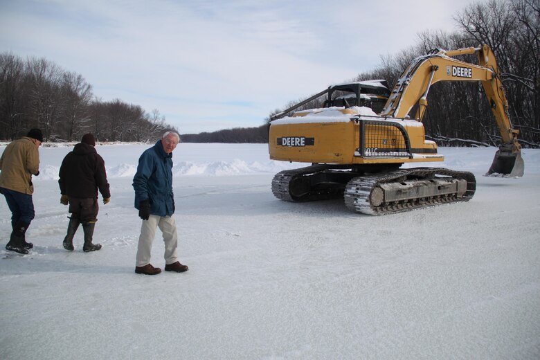 CRREL engineers, current and retired, work onsite with Missisquoi National Wildlife Refuge officials to lend guidance on safely moving the excavator across the ice bridge. CRREL retired Engineer Ginny Frankenstein, right, and CRREL Engineer Leonard Zabilansky, left, provide years of expertise working and researching ice.