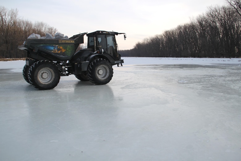 A truck hauls rock across the Missisquoi River via an ice bridge created for this task. A total of 2,200 tons of rock was hauled over a five-day period.