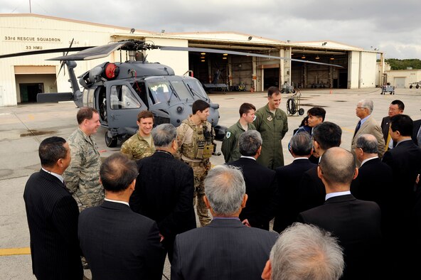 Members of the 31st and 33rd Rescue Squadrons brief Japan-American Air Force Goodwill Association on Air Force rescue capabilities and responsibilities in front of a U.S. Air Force HH-60G Pave Hawk helicopter on Kadena Air Base, Japan, March 5, 2014. JAAGA is a private organization organized by Japan Air Self Defense Force veterans in order to maintain a positive relationship between the two nations' aerial branches. (U.S. Air Force photo by Senior Airman Maeson L. Elleman)