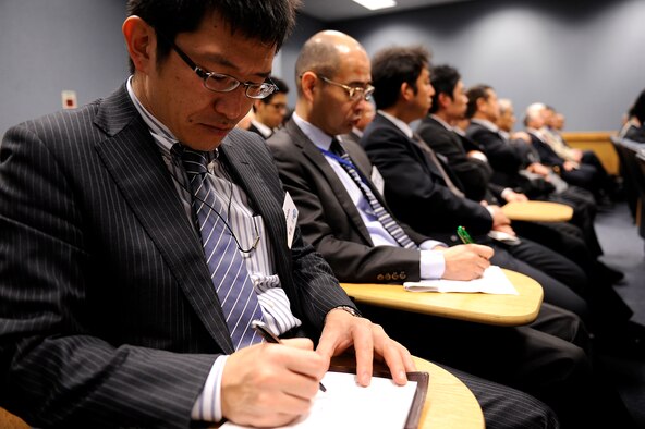 A member of the Japan-American Air Force Goodwill Association takes notes during a briefing on Kadena Air Base, Japan, March 5, 2014. During the visit, Kadena Airmen briefed JAAGA members from mainland Japan on the different capabilities the base provides as they toured different aircraft from the F-15 Eagle and F-22 Raptor to the HH-60 Pave Hawk helicopter and KC-135 Stratotanker. (U.S. Air Force photo by Senior Airman Maeson L. Elleman)