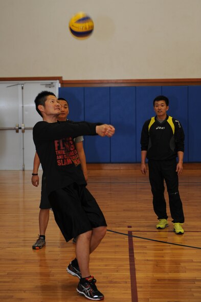 Japan Air Self-Defense Force service members practice passing a volleyball before a game against the Kadena Chiefs Group at the Risner Fitness Center, March 5, 2014. They participated in four games of volleyball, strengthening the bilateral partnership and creating long lasting relationships with the JASDF. (U.S. Air Force photo by Airman 1st Class Hailey R. Staker)