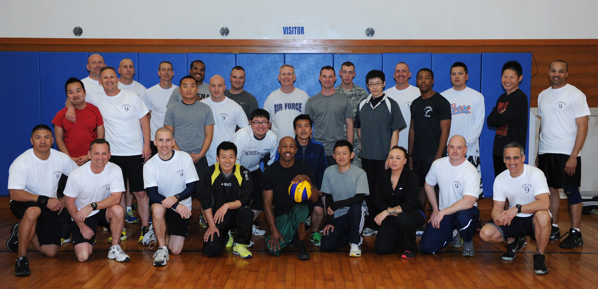 Members of the Kadena Chiefs Group, Japan Air Self-Defense Force, U.S. Air Force and Army service members pose for a group photo before a volleyball game at the Risner Fitness Center, March 5, 2014. The group participated in four games of volleyball, strengthening the bilateral partnership and creating long lasting relationships with the JASDF. (U.S. Air Force photo by Airman 1st Class Hailey R. Staker)