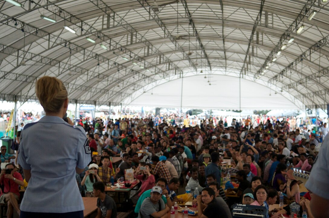 CHANGI, Singapore—Master Sergeant Lara Murdzia, Band of the Pacific-Hawaii, sings to an international crowd at the Singapore Air Show, Feb. 12, 2014. The group played 9 shows to over 100K audience members throughout their tour. The Band of the Pacific-Hawaii went to Singapore in support of the air show, the U.S. Embassy, and to improve international relations. (US Air Force Photo/ SrA Andy Detra/released)