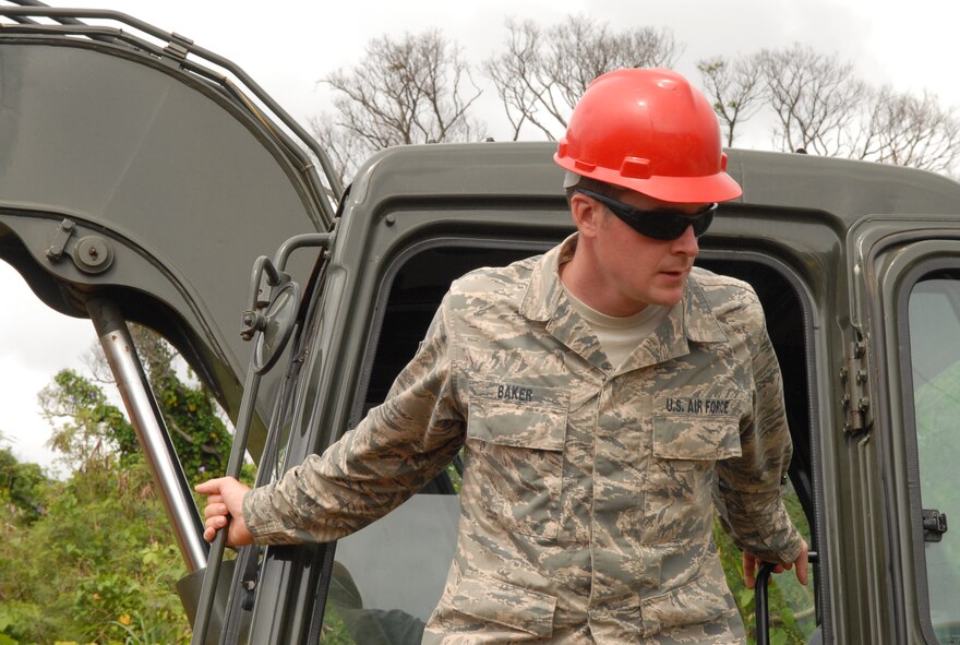 U.S. Air Force Staff Sgt. Justin Baker, 18th Civil Engineer Squadron heavy equipment operator, climbs out of an excavator on the job site of a water main break, Kadena Air Base, Japan, March 5, 2014. Baker was excavating a hole to repair a water pipe and save the base from losing water. (U.S. Air Force photo by Airman 1st Class Stephen G. Eigel)