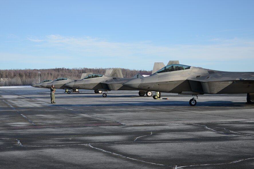 Staff Sgt. Michael Campbell, 477th Aircraft Maintenance Squadron, relays hand signals to an F-22 pilot from the 302nd Fighter Squadron as he taxies into the End of Runway inspection area during the 477th Fighter Group Unit Training Assembly weekend here March 1. During an end of runway inspection the maintainers inspect the landing gear, hydraulic systems, weapons systems and all exterior panels and doors for leaks, loose or missing hardware or other damage that would be unsafe for flight. The UTAs are an opportunity for the pilots in the 302nd Fighter Squadron to conduct Reserve flying operations. During the week the Reserve pilots and maintainers integrate with their active duty counterparts in the 525th and 90th Fighter Squadrons. (U.S. Air Force photo/Tech. Sgt. Dana Rosso)