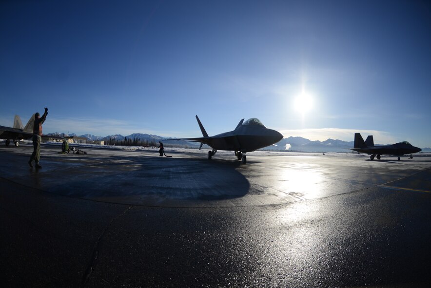 Staff Sgt. Michael Campbell, 477th Aircraft Maintenance Squadron, relays hand signals to an F-22 pilot from the 302nd Fighter Squadron as he taxies into the End of Runway inspection area during the 477th Fighter Group Unit Training Assembly weekend here March 1. During an end of runway inspection the maintainers inspect the landing gear, hydraulic systems, weapons systems and all exterior panels and doors for leaks, loose or missing hardware or other damage that would be unsafe for flight. The UTAs are an opportunity for the pilots in the 302nd Fighter Squadron to conduct Reserve flying operations. During the week the Reserve pilots and maintainers integrate with their active duty counterparts in the 525th and 90th Fighter Squadrons. (U.S. Air Force photo/Tech. Sgt. Dana Rosso)