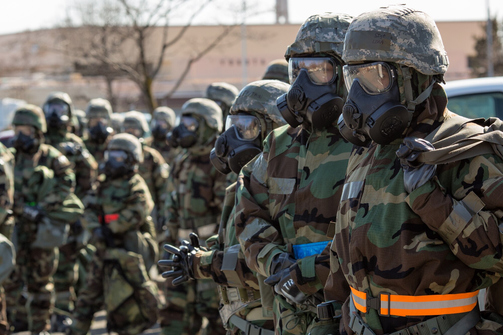 Yokota Airmen wait patiently as they go through the contamination control area during a Samurai Readiness Inspection at Yokota Air Base, Japan, March 6, 2014. The Inspection is made up of a variety of scenarios, which test the Airmen’s ability to handle potential real world situations in a safe environment. (U.S. Air Force photo by Osakabe Yasuo/Released)