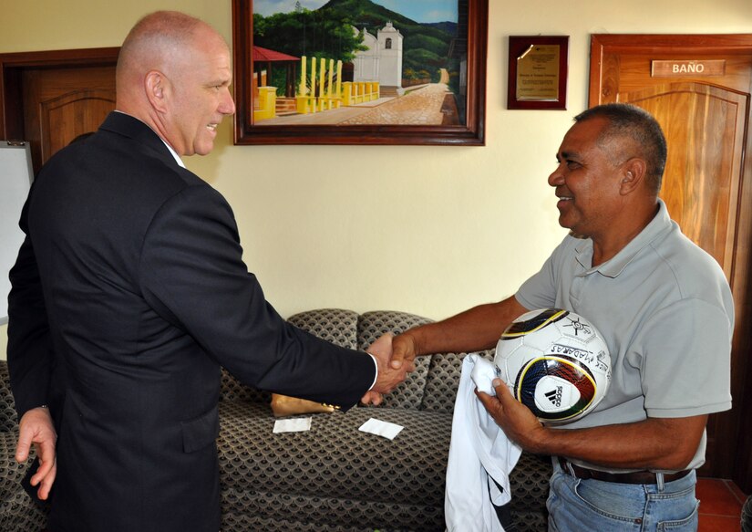 U.S. Army Col. Thomas Boccardi shakes hands with Francisco Mendez, Mayor of Lejamani, during a visit to Lejamani, Honduras, March 5, 2014.  Boccardi spent the afternoon visiting with local leaders and discussing building on the strong relationship between Joint Task Force-Bravo and the local communities surrounding Soto Cano Air Base.  Boccardi also presented the mayor with a collection of soccer balls and jerseys on behalf of the non-profit organization "Kick for Nick."(U.S. Air Force photo by Capt. Zach Anderson)