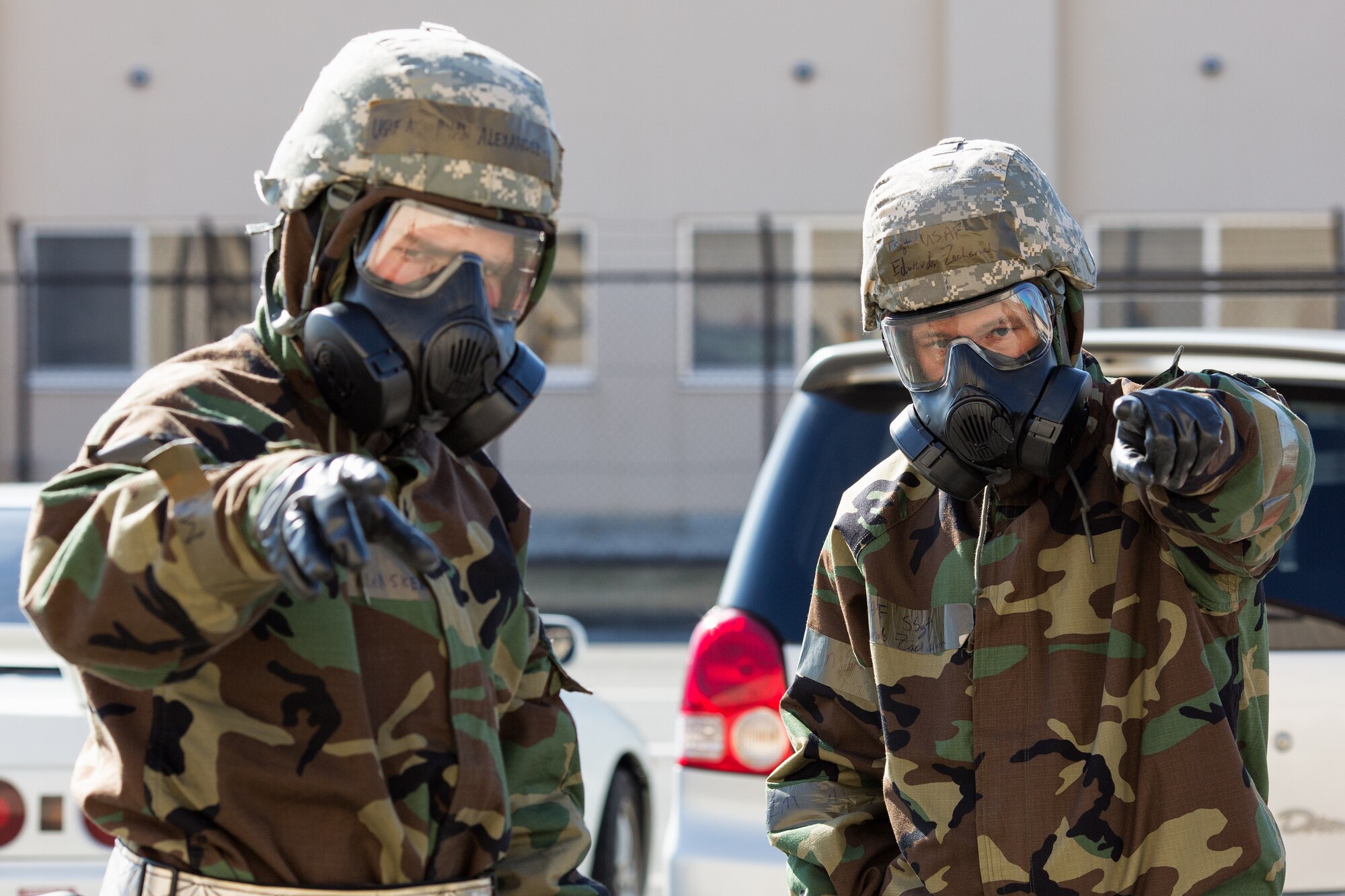 Right, Tech. Sgt. Zachariah Edwards points out the decontamination area to Airman 1st Class Ryan Alexandermansker during a Samurai Readiness Inspection at Yokota Air Base, Japan, March 6, 2014. Edwards and Alexandermansker are both from the 374th Maintenance Squadron. (U.S. Air Force photo by Osakabe Yasuo/Released)