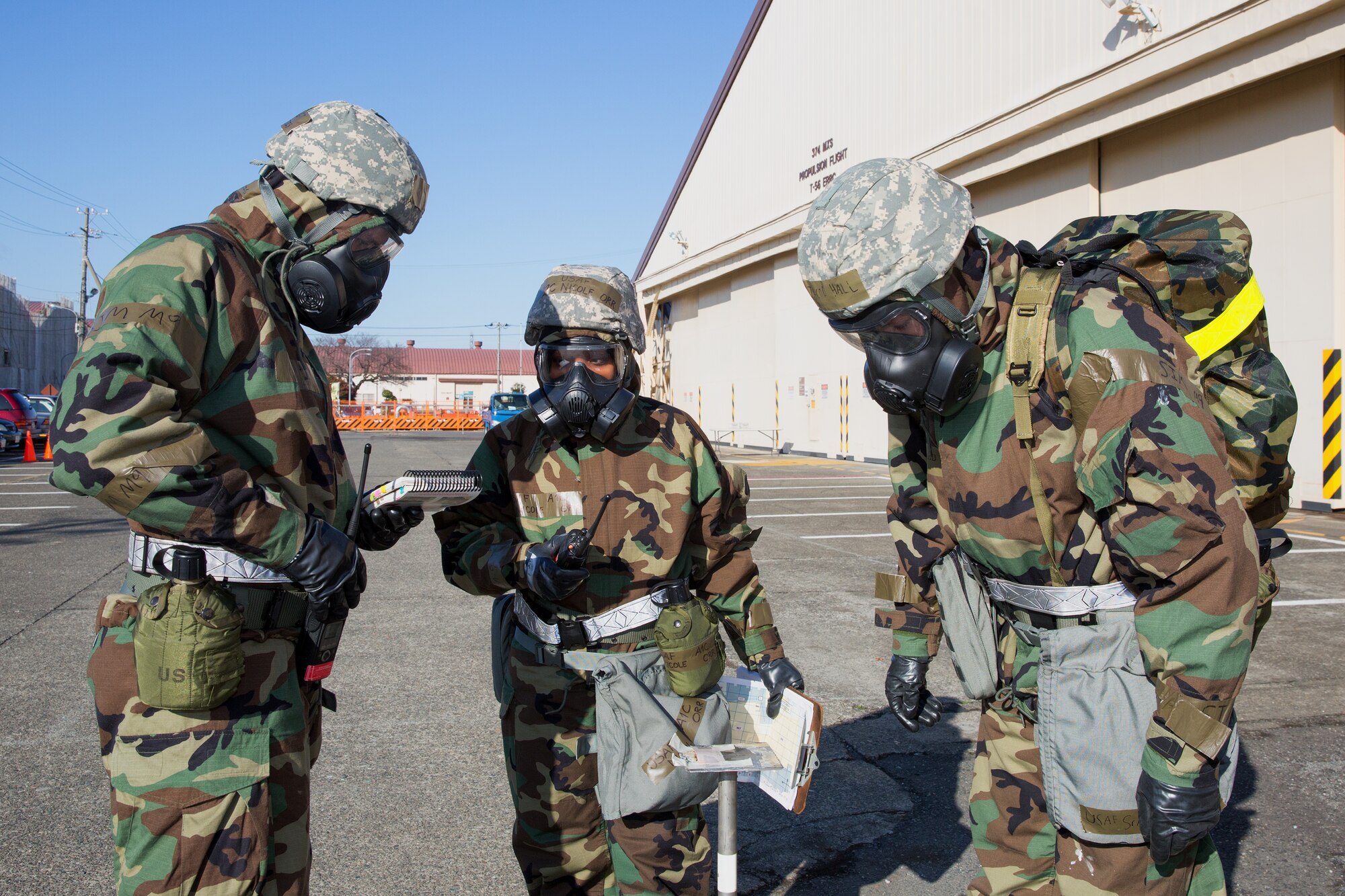 Airmen from the 374th Maintenance Squadron inspect simulated M-9 paper during a Samurai Readiness Inspection at Yokota Air Base, Japan, March 6, 2014. The readiness inspection was designed to evaluate areas such as rapid mobility response to simulated contingencies and providing airlift support to military and non-combatant evacuation. (U.S. Air Force photo by Osakabe Yasuo/Released)