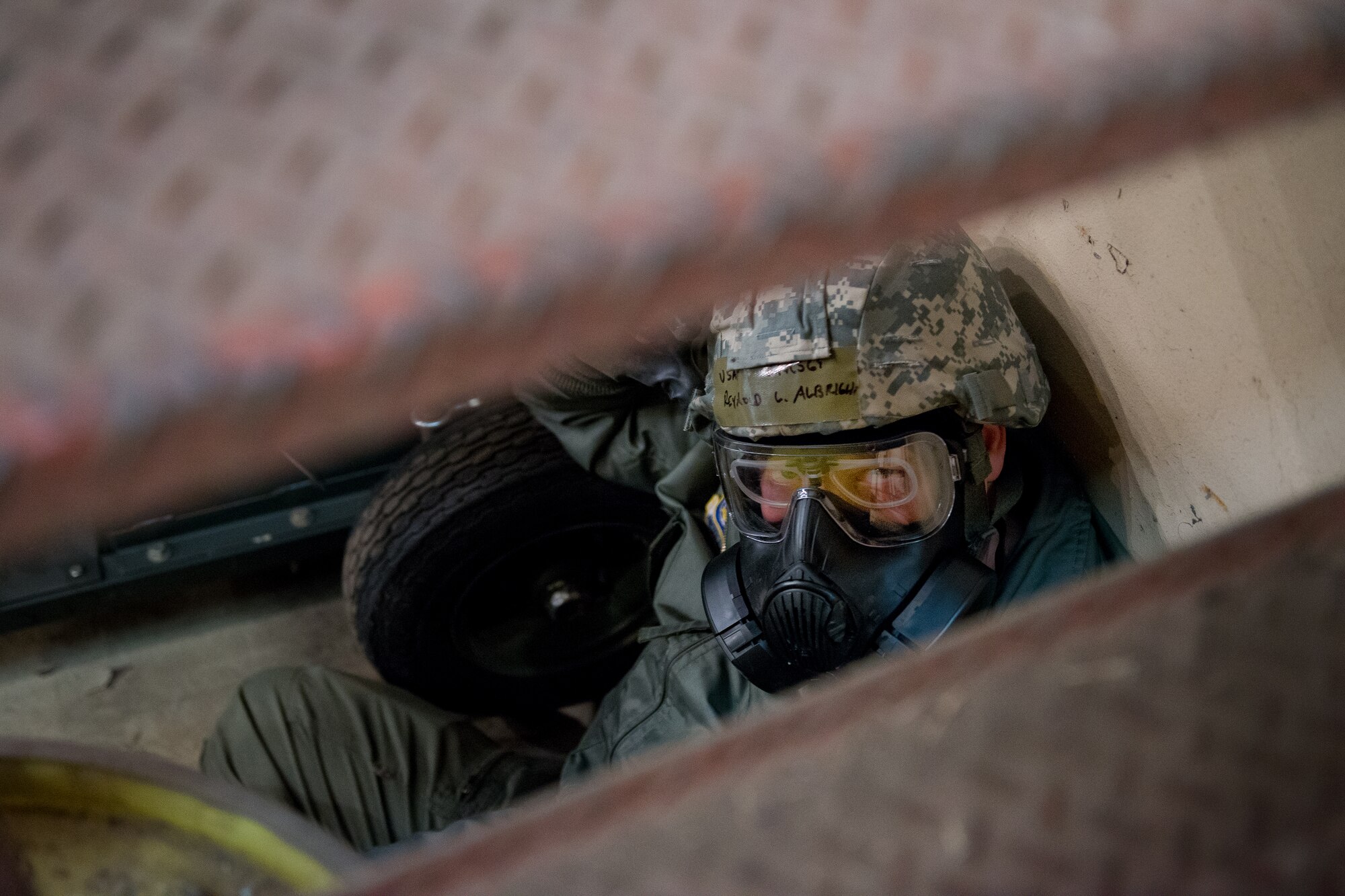 Chief Master Sgt. Reynold Albright, 36th Airlift Squadron loadmaster, takes cover during a Samurai Readiness Inspection at Yokota Air Base Japan, March 5, 2014. The Samurai Readiness Inspection tests Yokota’s ability to carry out its mission as the airlift hub in the Pacific during contingency operations. (U.S. Air Force photo by Staff Sgt. Dustin Payne/Released)