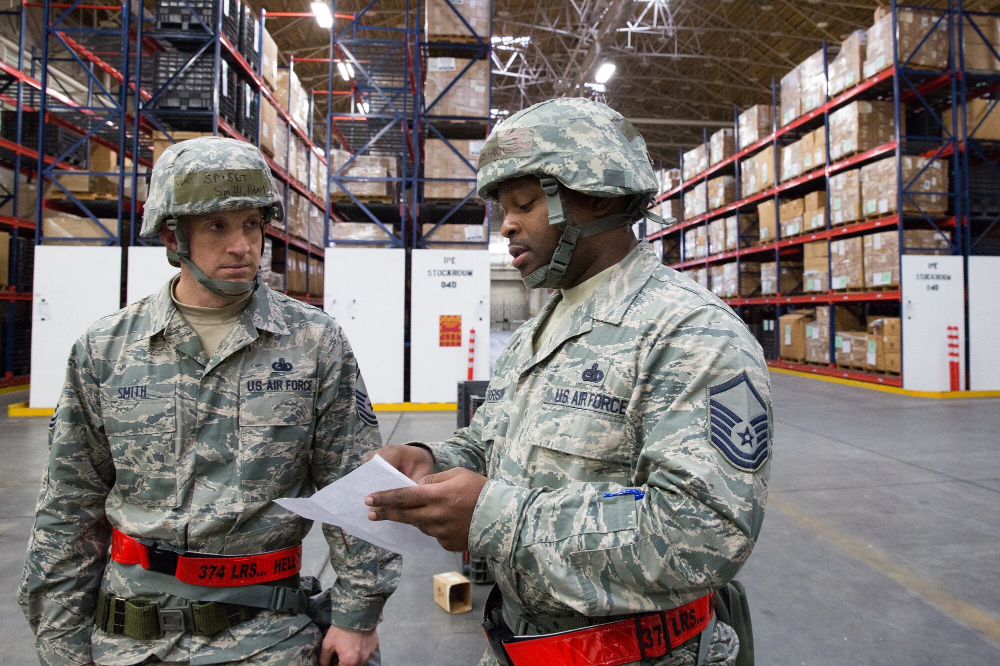 (Left to right)  Senior Master Sgt. Robert Smith and Master Sgt. Decarlos Harrison, both from the 374th Logistics Readiness Squadron, review an individual protective equipment checklist during a Samurai Readiness Inspection at Yokota Air Base, Japan, March 5, 2014. Yokota Airmen participated in a week-long exercise designed to maintain their operational readiness capabilities. (U.S. Air Force photo by Osakabe Yasuo/Released) 